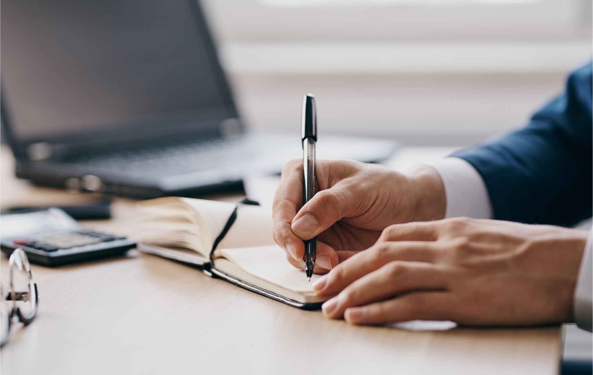 Expert Witness Taking Notes in a Client Meeting