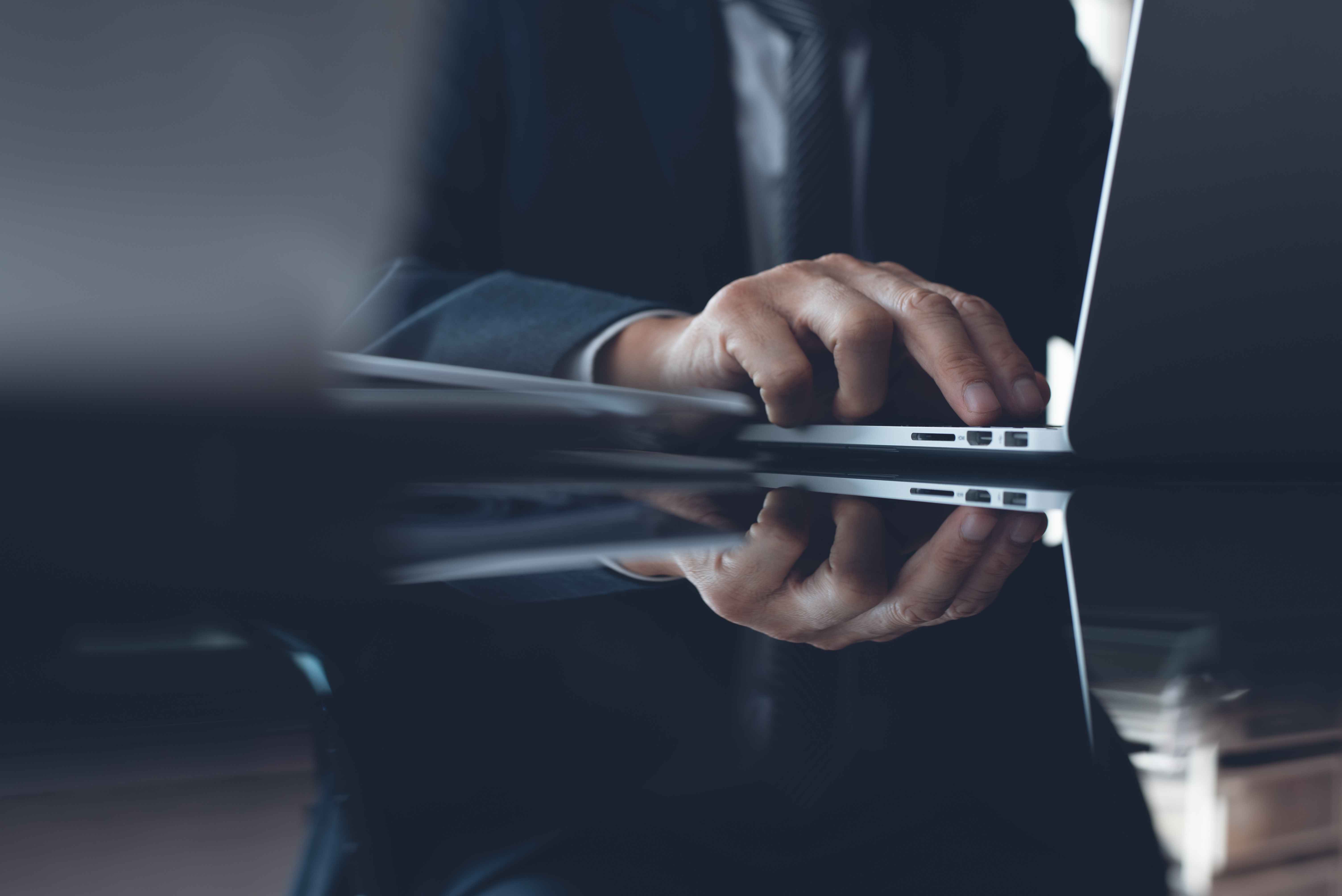 Expert Witness Working On a Laptop-min